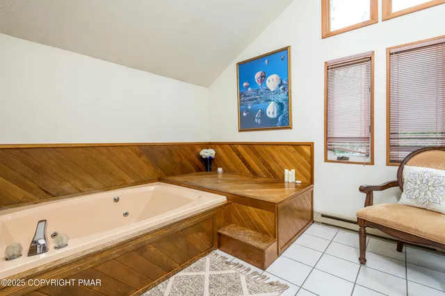 a bathroom with a bathtub and a shower