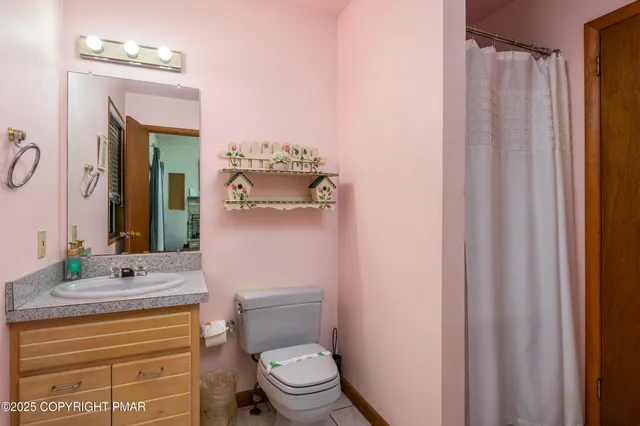 a bathroom with a toilet a sink and a mirror