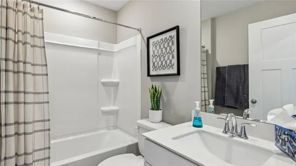 a bathroom with a granite countertop bathtub shower sink and mirror