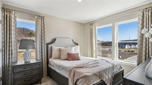 a bedroom with a large bed and a window