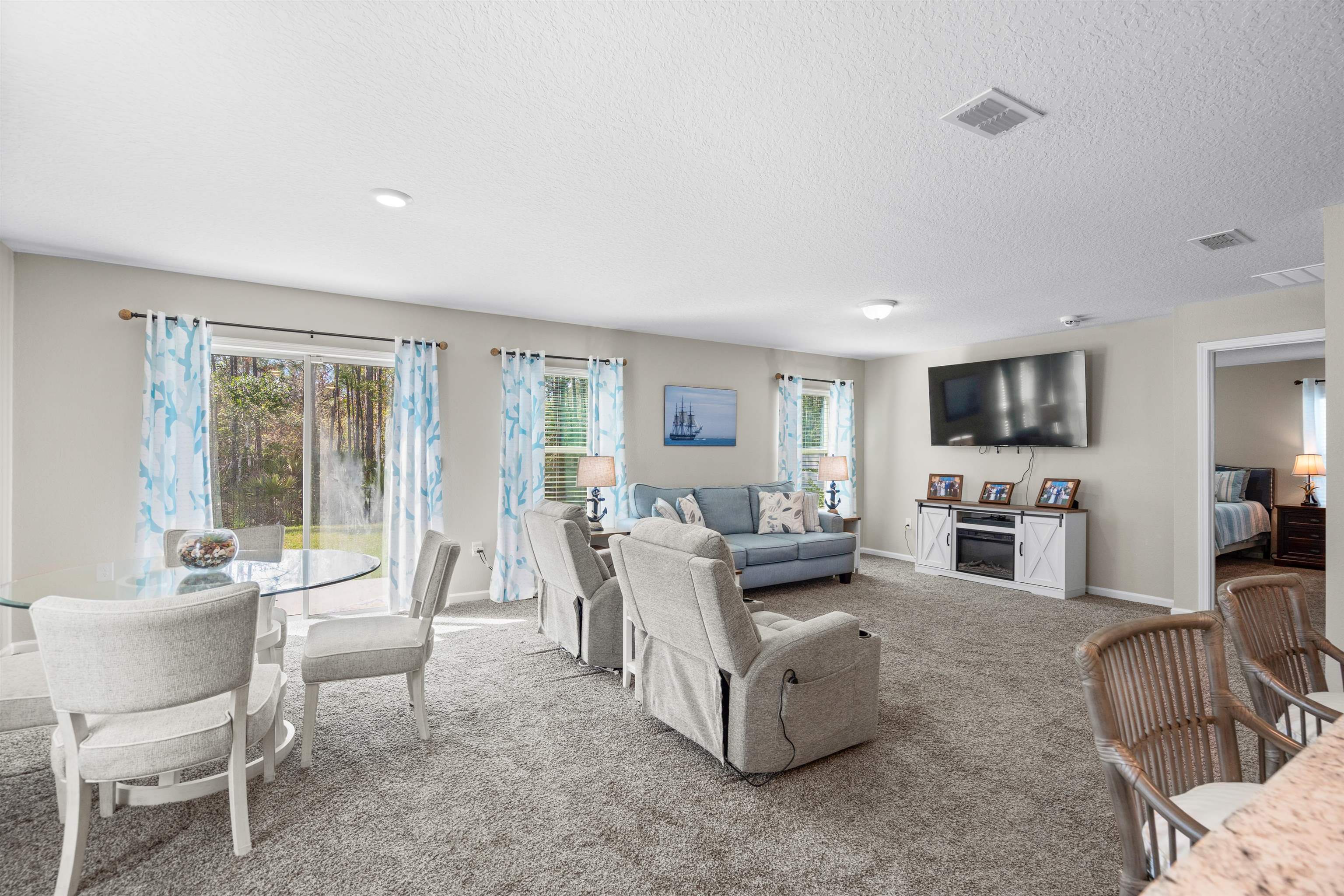 408 Falcon Ridge Road St. Augustine, FL 32084 - Photo 12 of 26 a living room with furniture and a flat screen tv