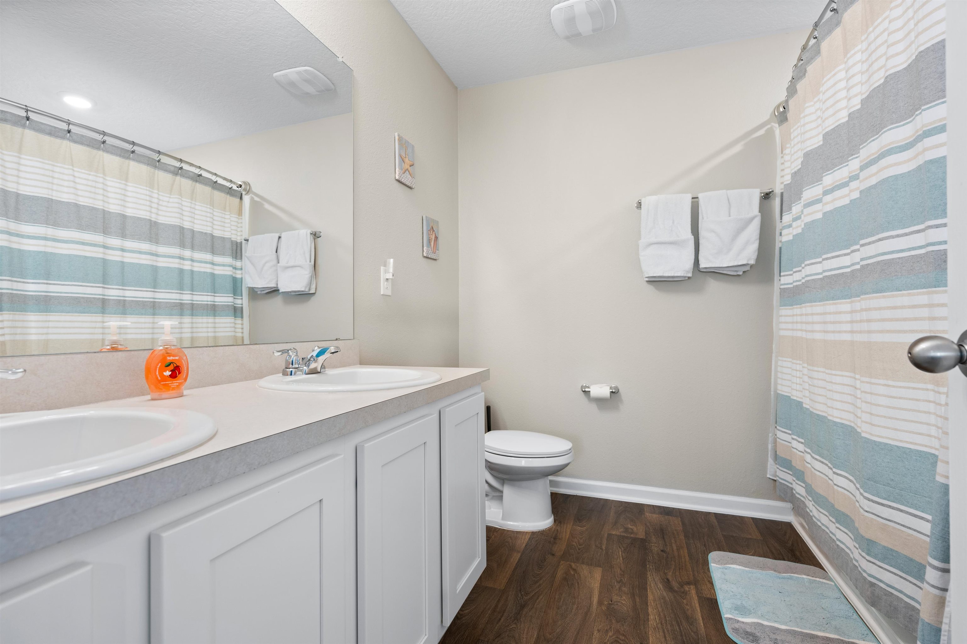 408 Falcon Ridge Road St. Augustine, FL 32084 - Photo 18 of 26 a bathroom with a sink a toilet and shower