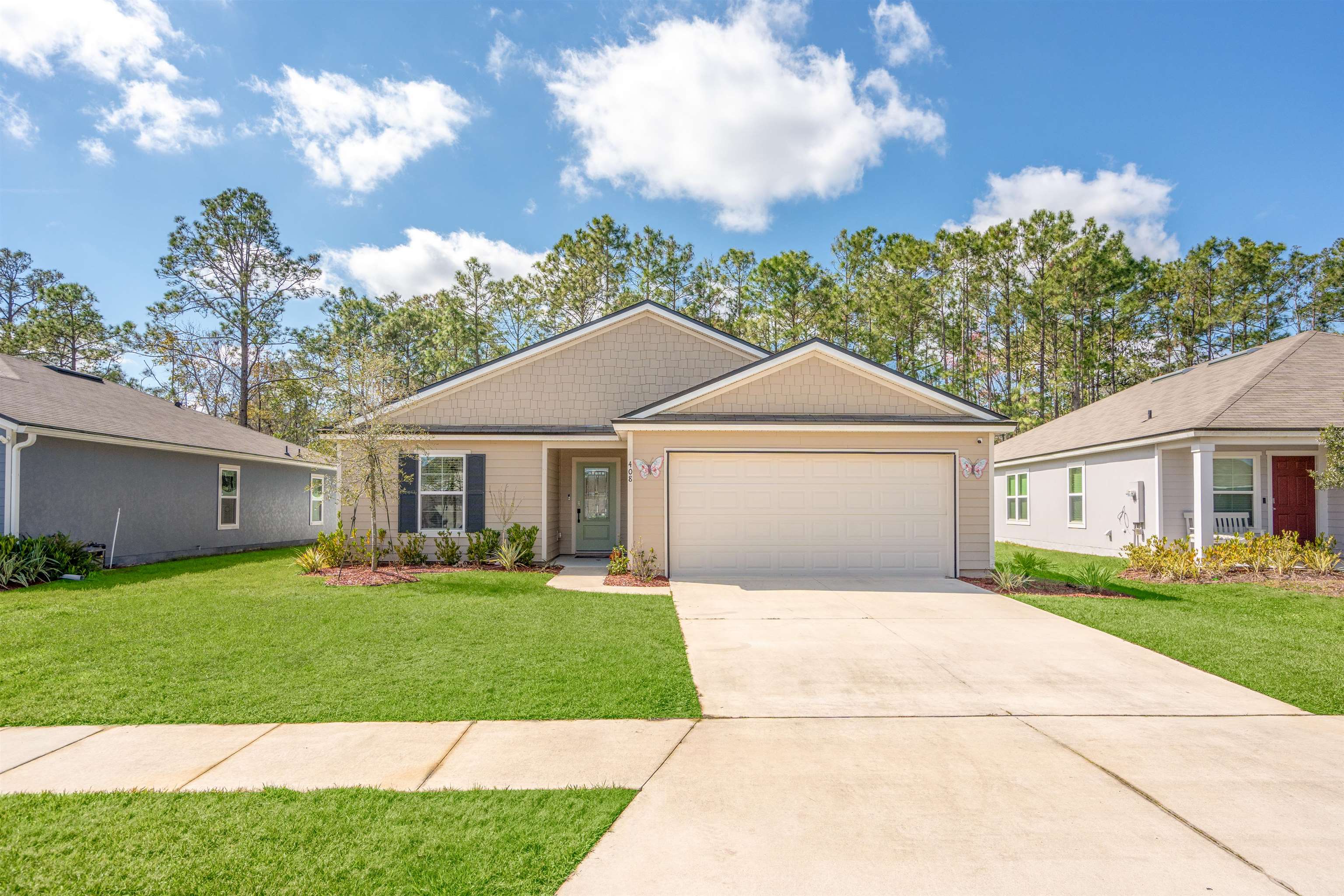 408 Falcon Ridge Road St. Augustine, FL 32084 - Photo 2 of 26 a front view of a house with a yard and trees