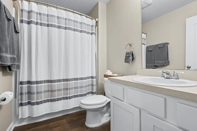a bathroom with a toilet a sink and a mirror