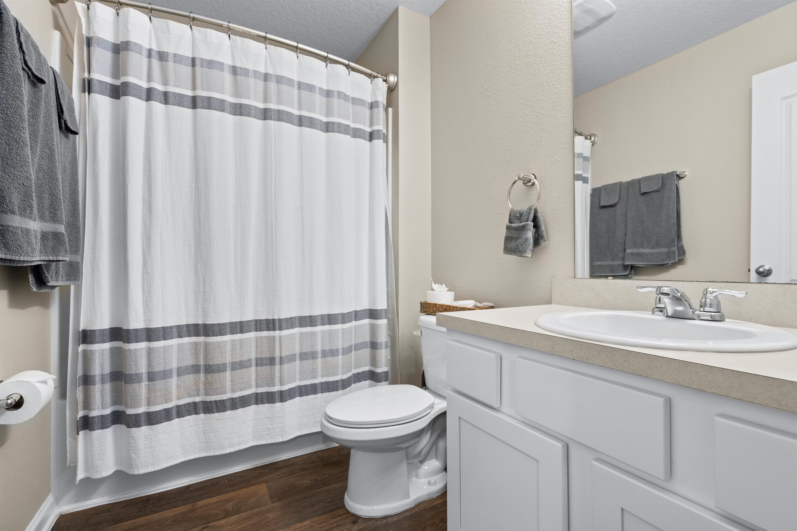 408 Falcon Ridge Road St. Augustine, FL 32084 - Photo 21 of 26 a bathroom with a toilet a sink and a mirror