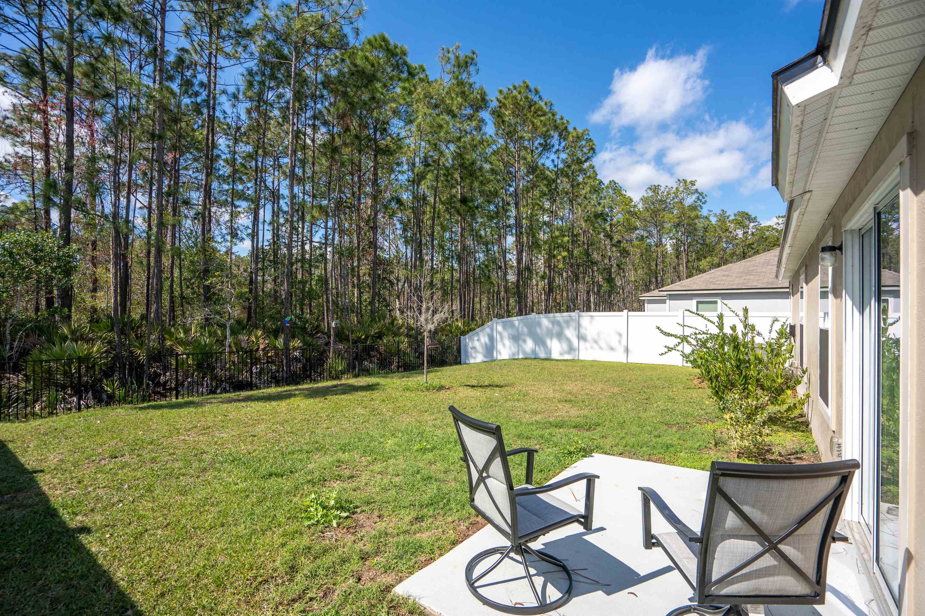 408 Falcon Ridge Road St. Augustine, FL 32084 - Photo 25 of 26 a view of a chairs and table in the patio