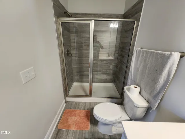 a bathroom with a toilet and a shower