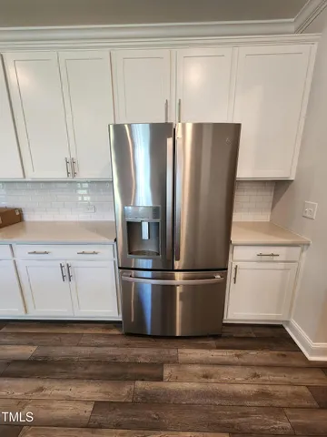 a refrigerator freezer sitting inside of a kitchen