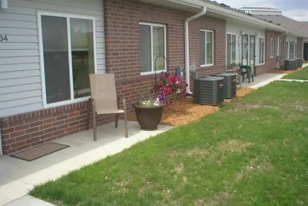 a view of a house with backyard and sitting area