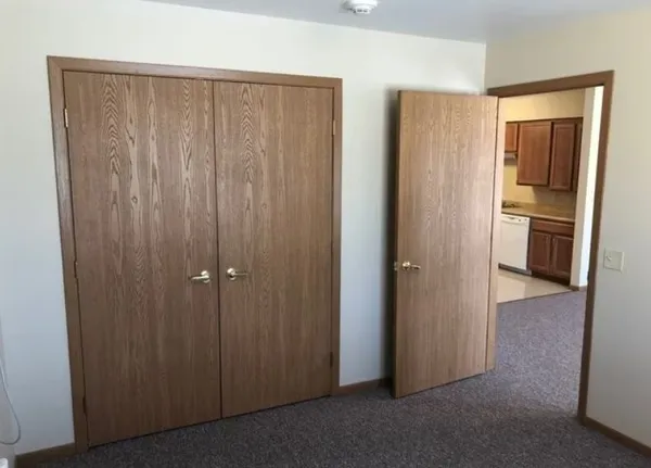 a view of a closet with wooden floor