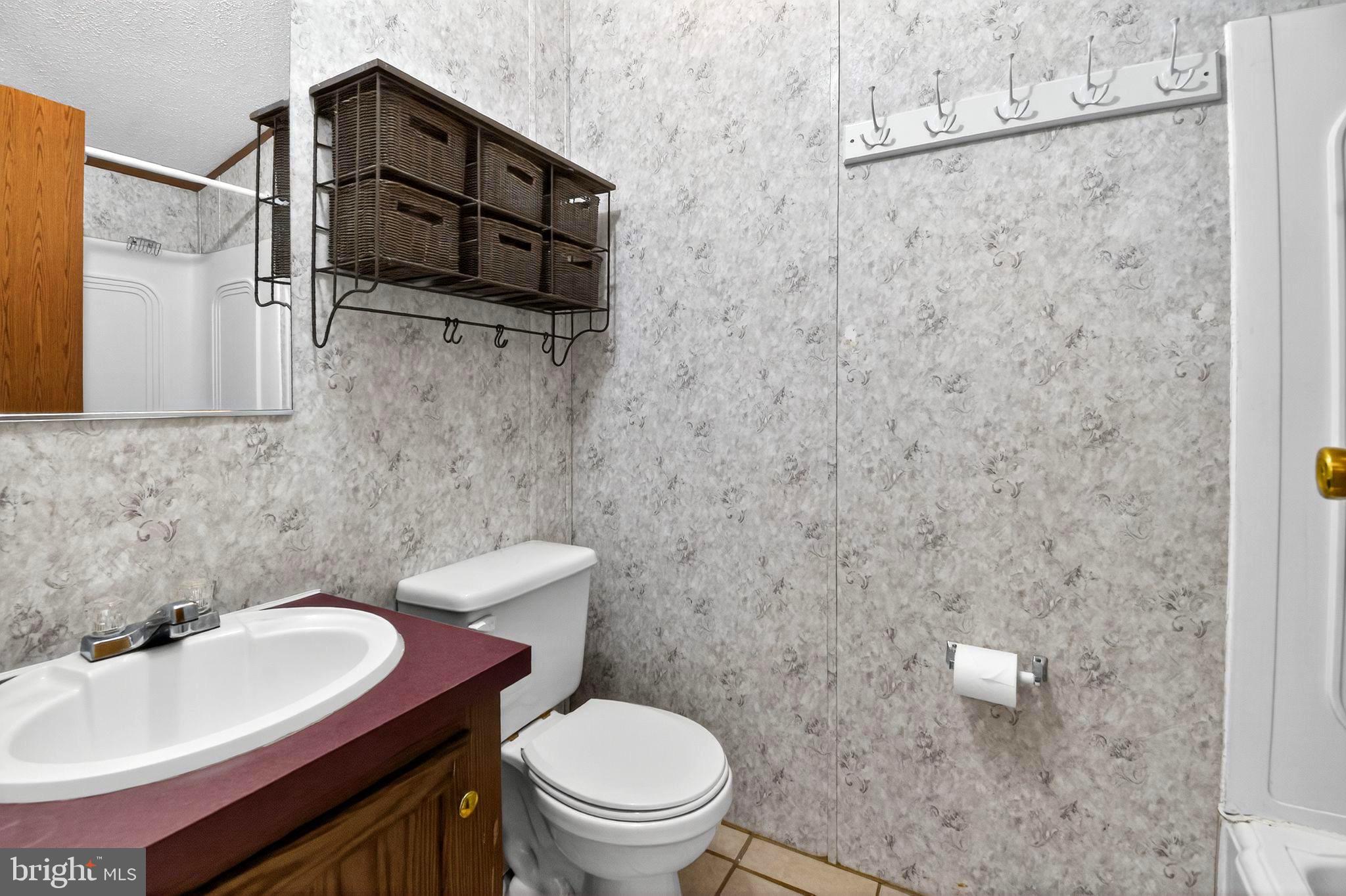 263 Konrad Morgan Way Lothian, MD 20711 - Photo 12 of 18 a bathroom with a sink a toilet and shower