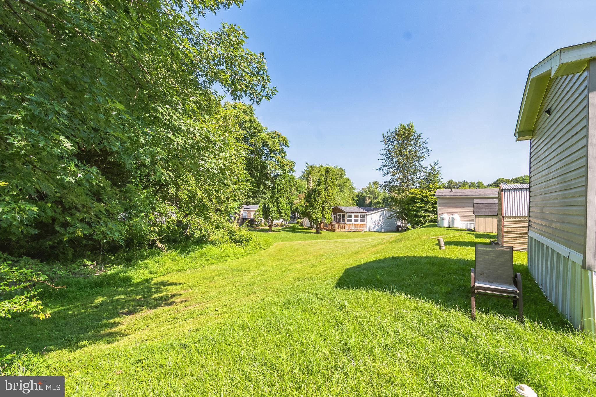 263 Konrad Morgan Way Lothian, MD 20711 - Photo 18 of 18 a backyard of a house with table and chairs