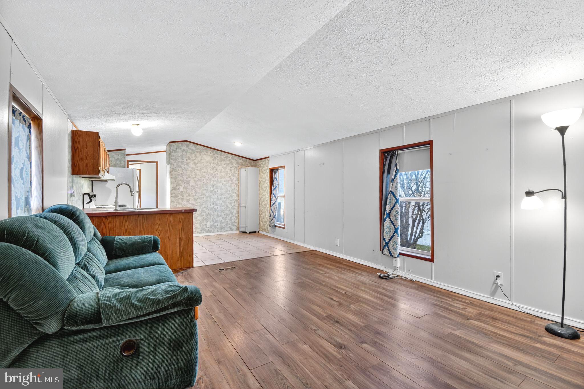 263 Konrad Morgan Way Lothian, MD 20711 - Photo 3 of 18 a living room with furniture and a wooden floor