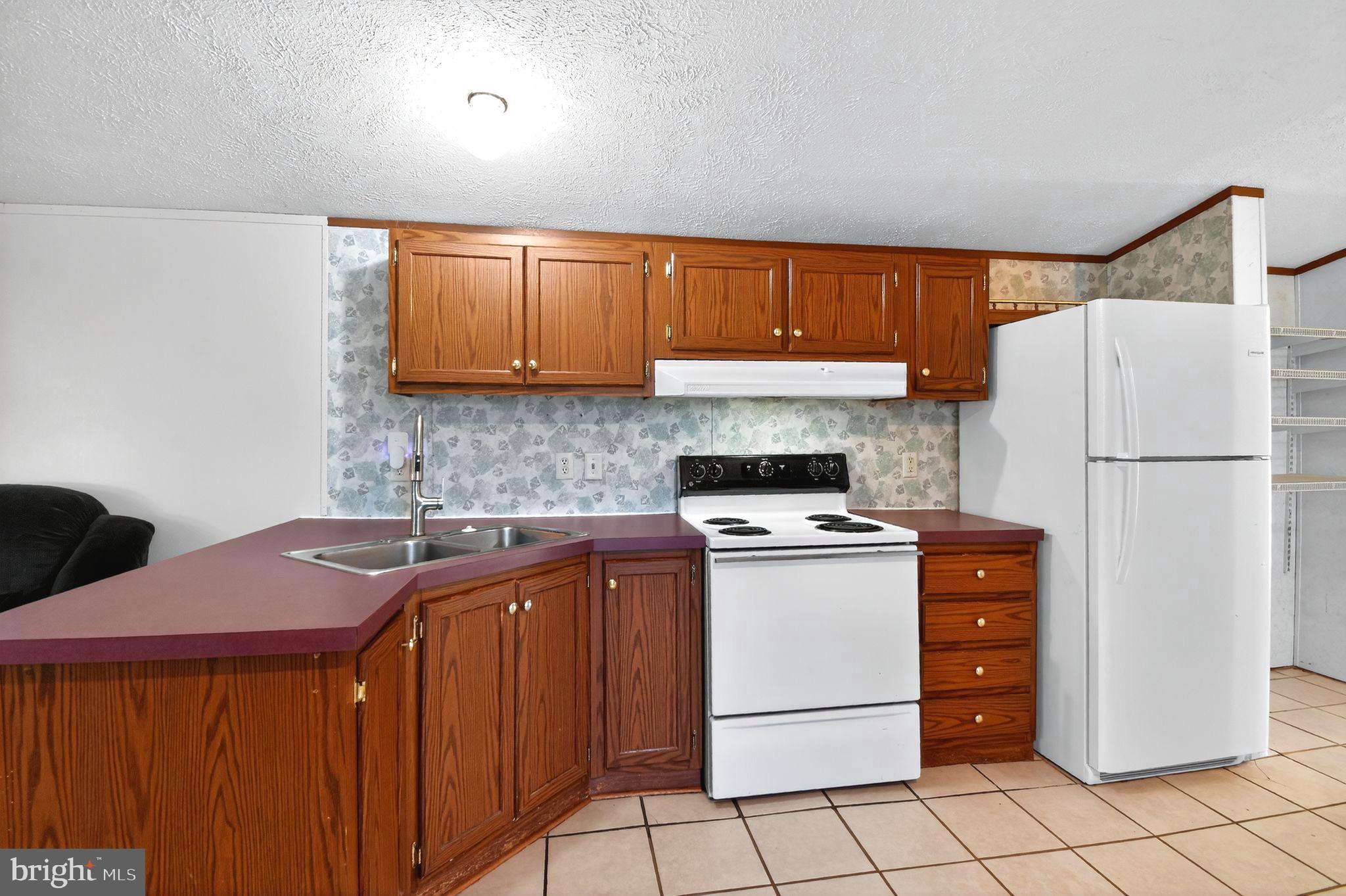 263 Konrad Morgan Way Lothian, MD 20711 - Photo 5 of 18 a kitchen with stainless steel appliances granite countertop a refrigerator sink and stove