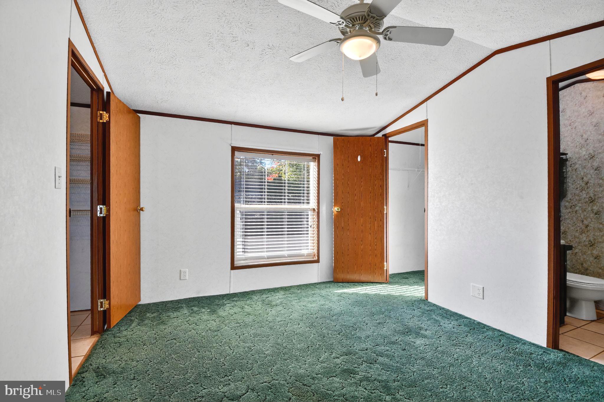 263 Konrad Morgan Way Lothian, MD 20711 - Photo 6 of 18 an empty room with window and ceiling fan