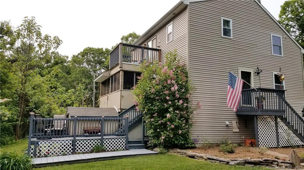 109 Woods Road Mansfield, CT 06250 - Photo 1 of 1 a view of a white house with a yard and potted plants