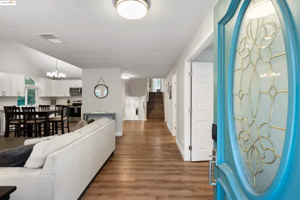 an entryway with wooden floor and windows