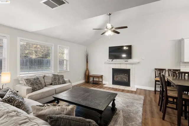 a living room with furniture a fireplace and a flat screen tv