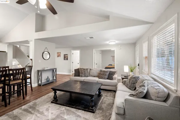 a living room with furniture a fireplace and a large window