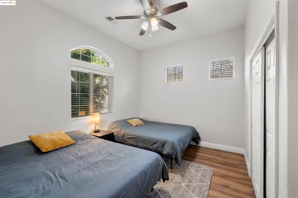 a bedroom with two beds and a chandelier