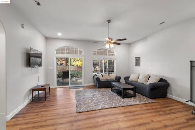 a living room with furniture a chandelier and a flat screen tv
