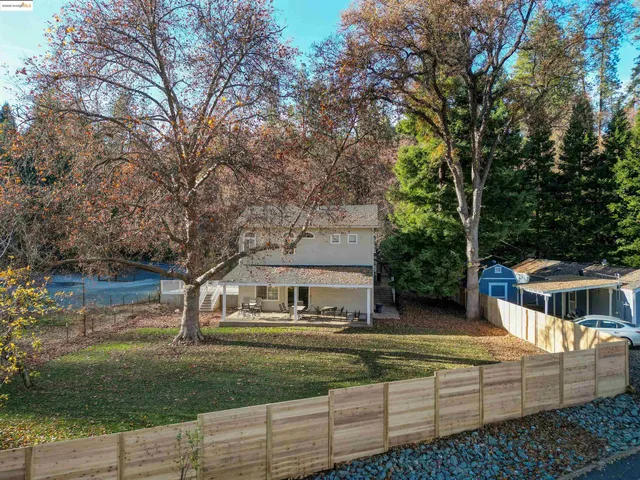 a view of house with a yard