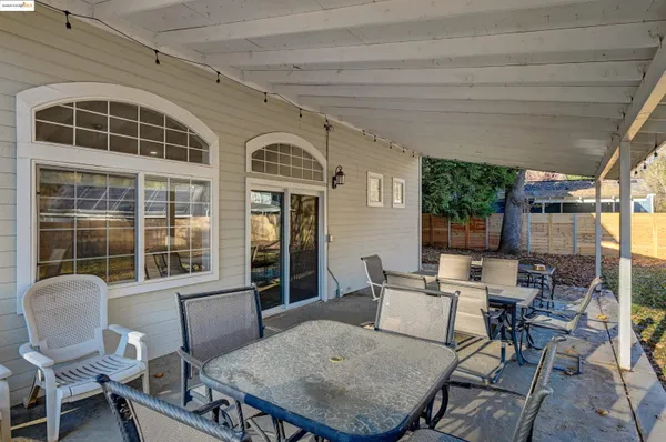a balcony with table and chairs