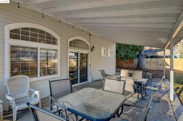 a balcony with table and chairs