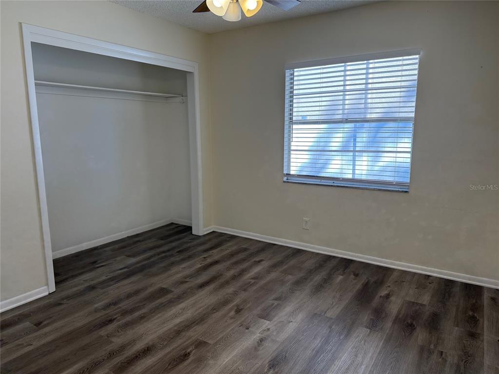 1740 West Walnut Street Tampa, FL 33607 - Photo 11 of 21 a view of an empty room with wooden floor and a window