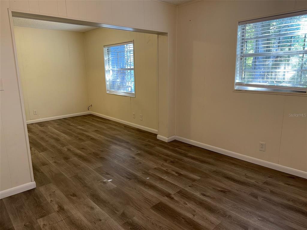 1740 West Walnut Street Tampa, FL 33607 - Photo 13 of 21 a view of an empty room with wooden floor and a window