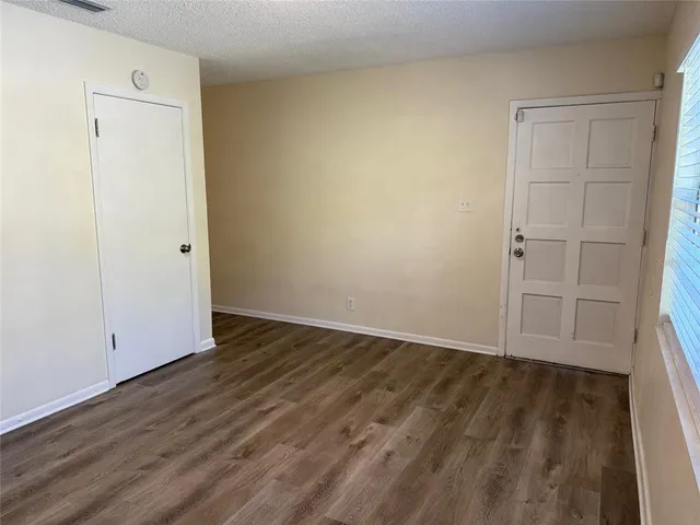 an empty room with wooden floor
