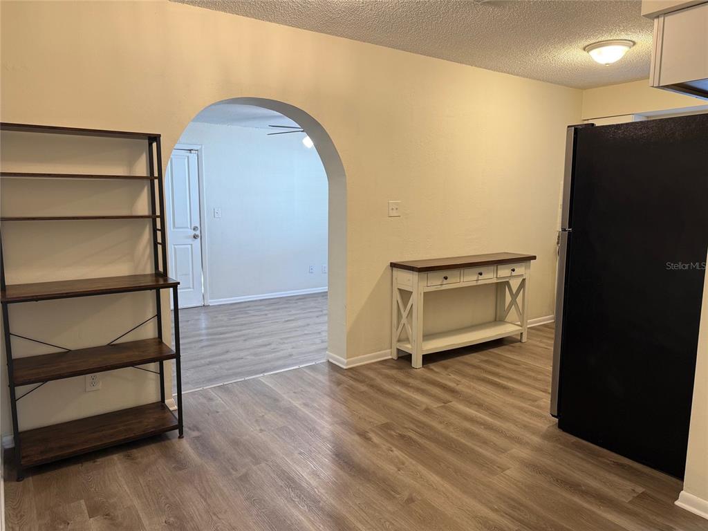 1740 West Walnut Street Tampa, FL 33607 - Photo 8 of 21 a view of an empty room with wooden floor and a window