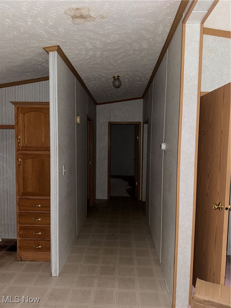 3690 Anderson Anthony Road Leavittsburg, OH 44430 - Photo 8 of 18 Hallway with crown molding, light flooring, and wallpapered walls