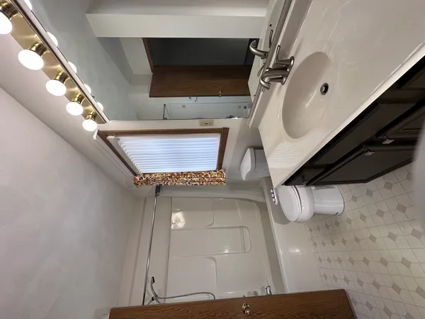 a bathroom with a sink a toilet and mirror