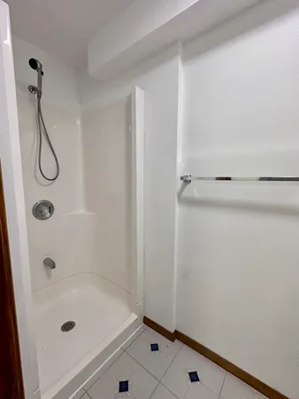 a view of an empty room with stairs and closet