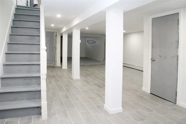 a view of a hallway with wooden shelves