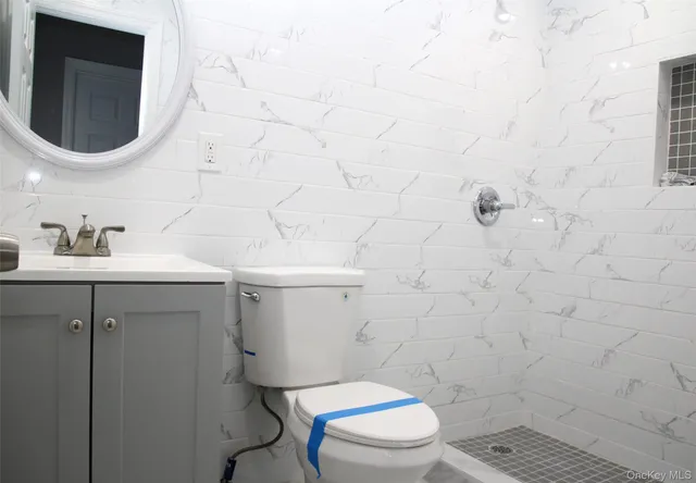 a white toilet sitting next to a bathroom sink