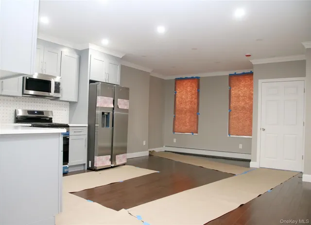 a kitchen with a refrigerator and a stove top oven