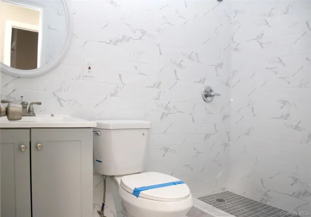 a bathroom with a sink mirror and toilet