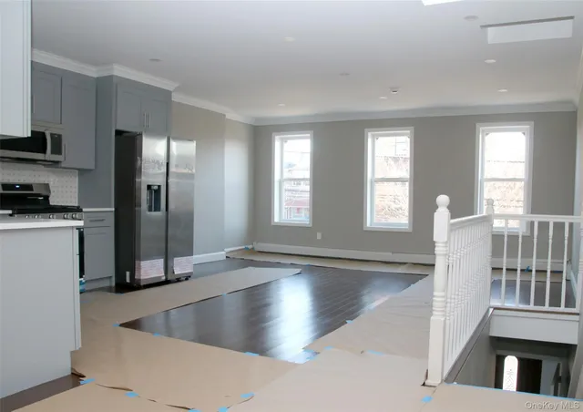 a view of a kitchen with a refrigerator table and chairs