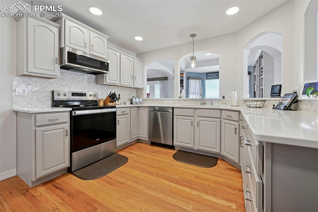 3430 Double Tree Court Colorado Springs, CO 80921 - Photo 19 of 50 a kitchen with stainless steel appliances granite countertop a sink and cabinets