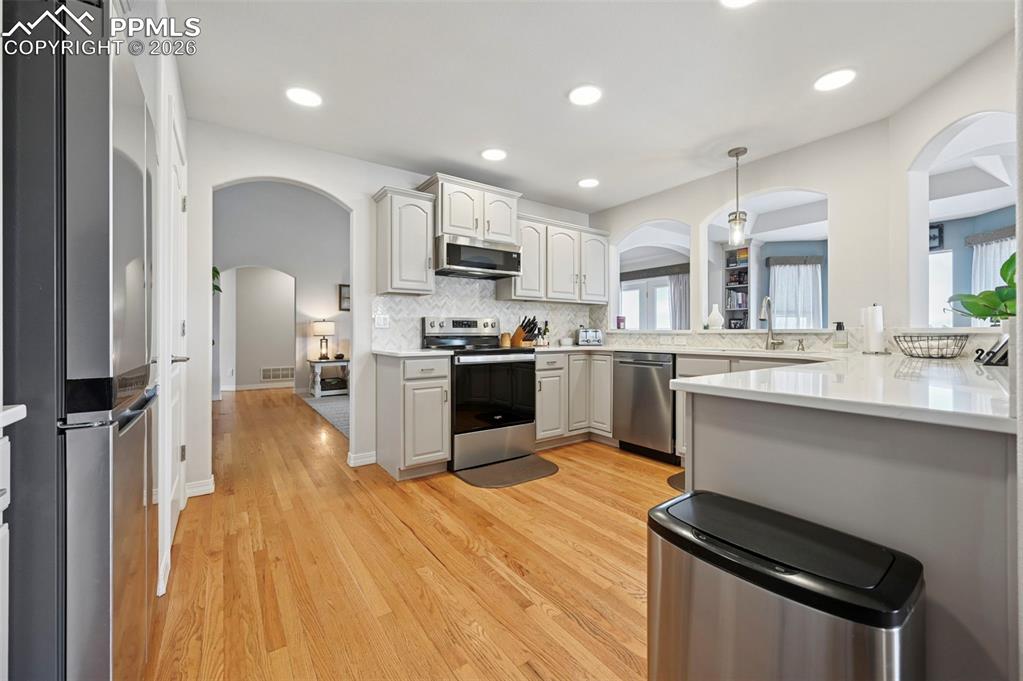 3430 Double Tree Court Colorado Springs, CO 80921 - Photo 22 of 50 a kitchen with stainless steel appliances kitchen island granite countertop a sink and cabinets