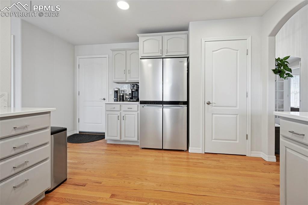 3430 Double Tree Court Colorado Springs, CO 80921 - Photo 23 of 50 a view of a kitchen with white cabinets and refrigerator