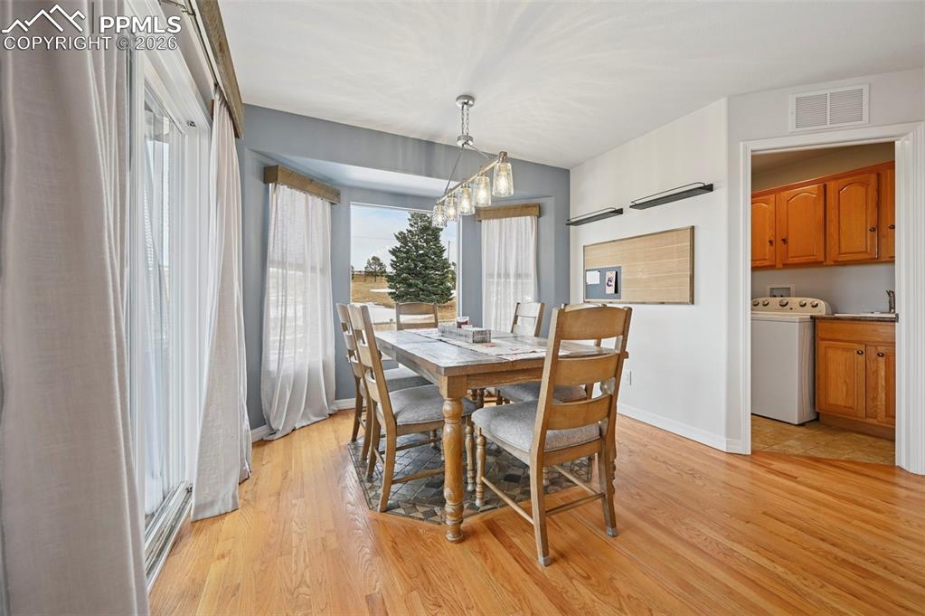 3430 Double Tree Court Colorado Springs, CO 80921 - Photo 26 of 50 a dining room with furniture window wooden floor