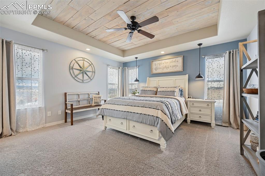 3430 Double Tree Court Colorado Springs, CO 80921 - Photo 28 of 50 a bedroom with a bed and a chandelier
