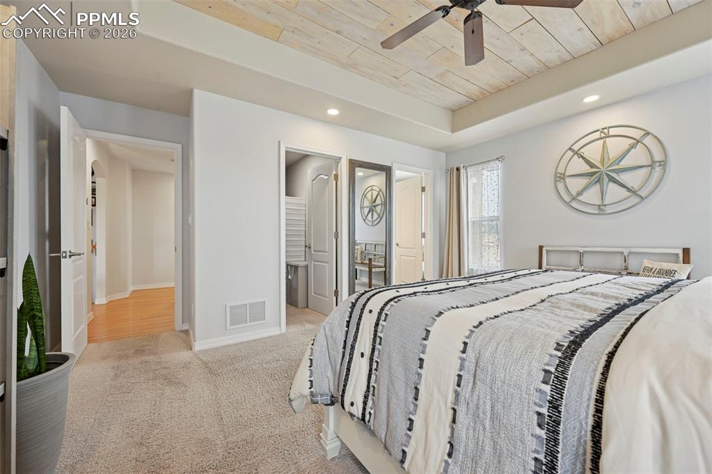 3430 Double Tree Court Colorado Springs, CO 80921 - Photo 29 of 50 a bedroom with a bed and a chandelier