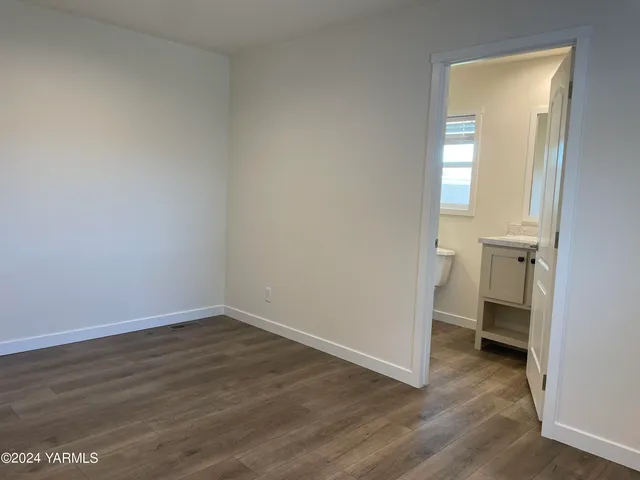 a view of a room with wooden floor and a sink