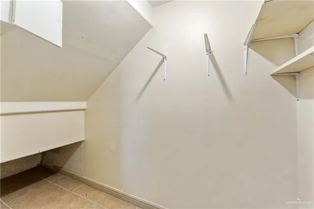 a bathroom with a granite countertop toilet sink and mirror