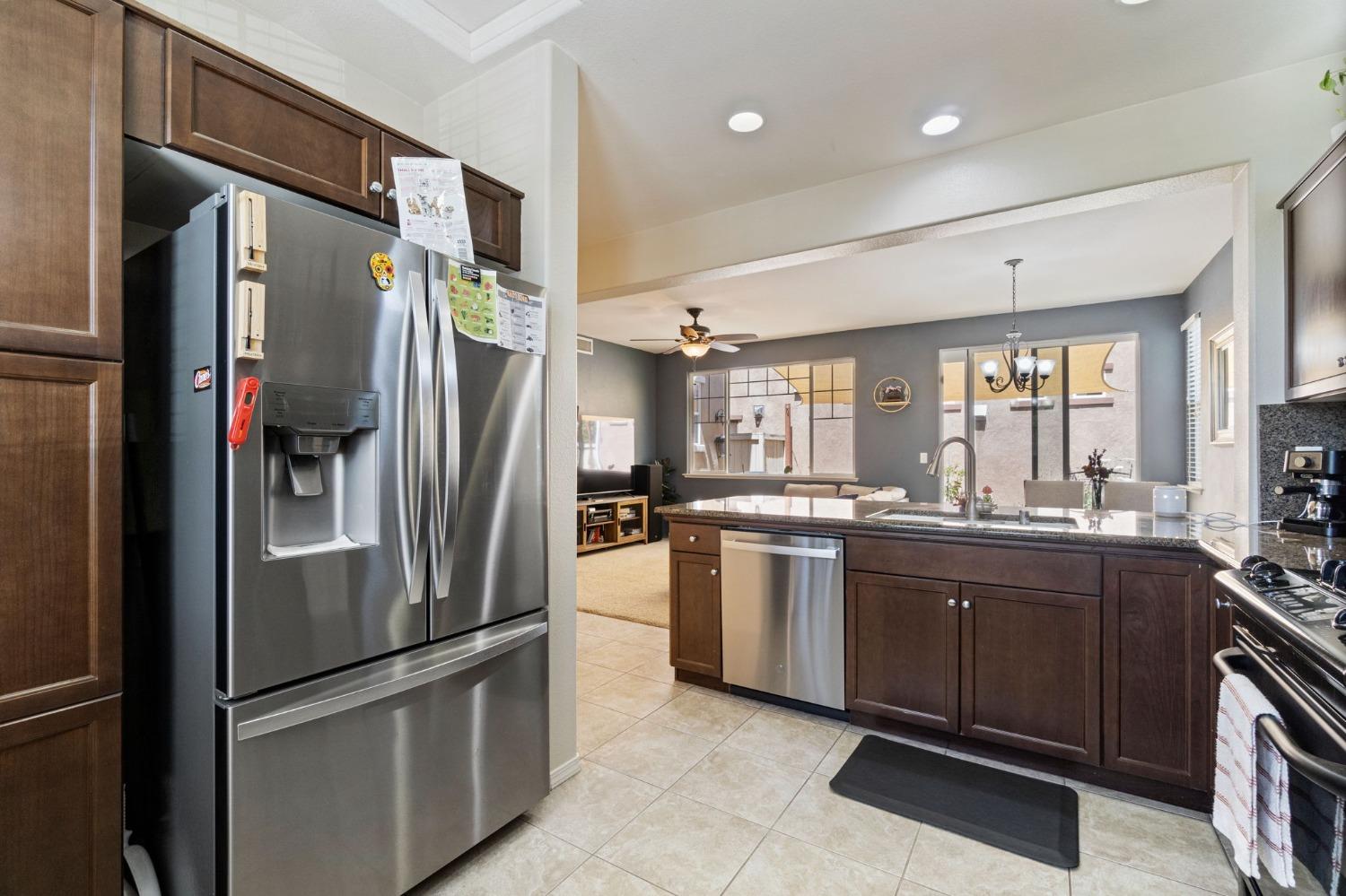 3915 Harlan Ranch Boulevard Clovis, CA 93619 - Photo 11 of 27 a kitchen with stainless steel appliances granite countertop a refrigerator and a sink