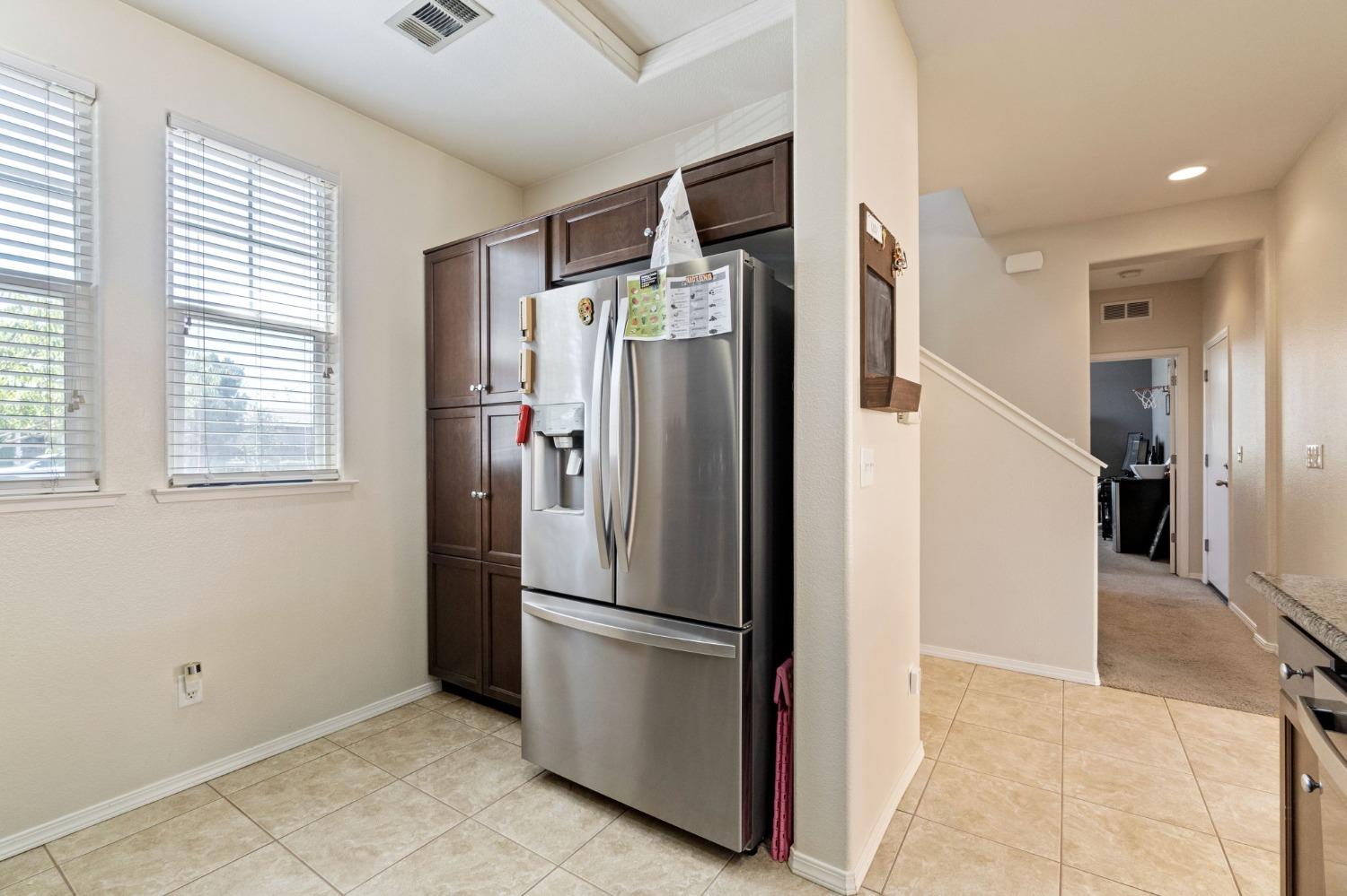 3915 Harlan Ranch Boulevard Clovis, CA 93619 - Photo 12 of 27 a view of a refrigerator in kitchen and an empty room